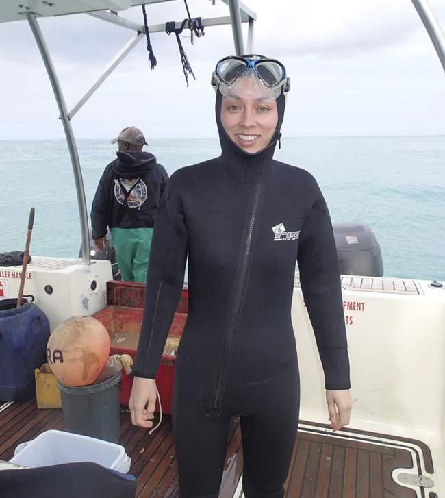 a woman wearing a diving suit and goggles