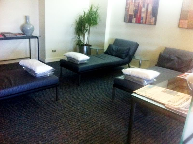 a room with a couch and chairs