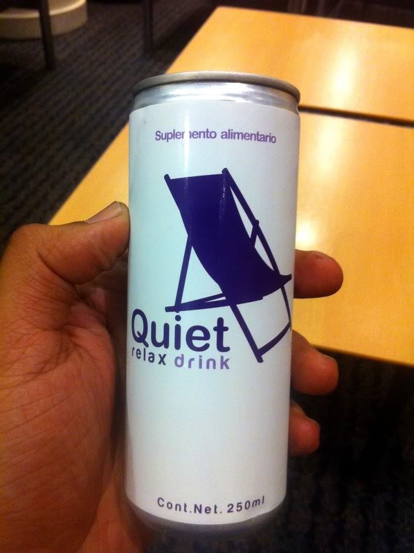 a hand holding a can of beverage