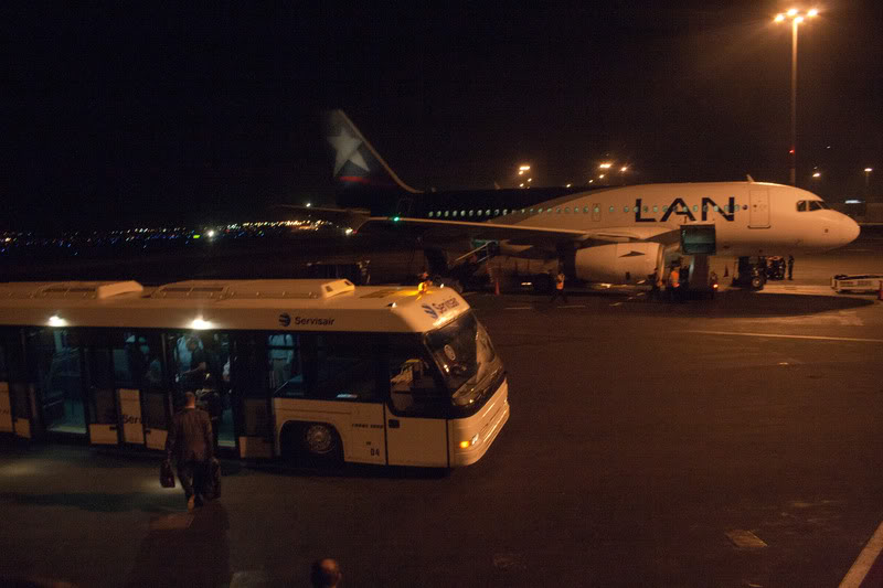 a bus and a plane at night
