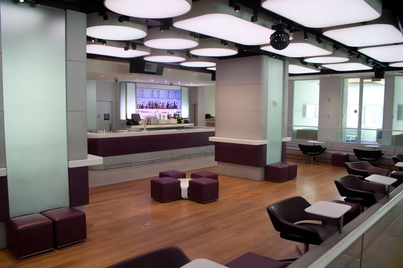a room with purple chairs and tables