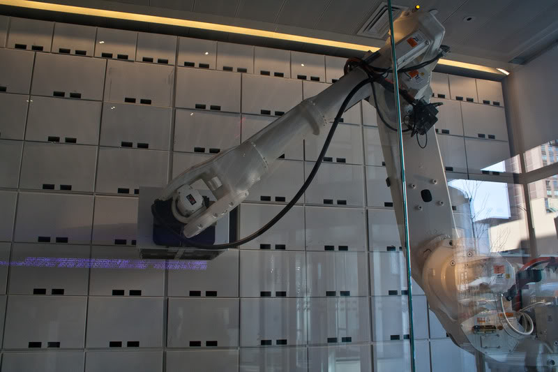 a white robot arm in a glass case