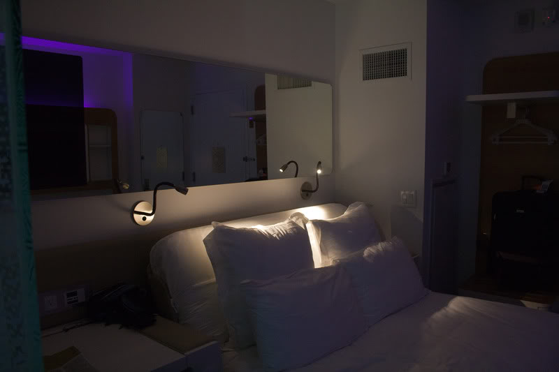 a bed with pillows and lights