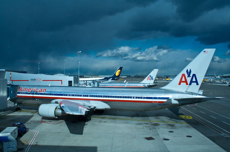 a group of airplanes parked at an airport