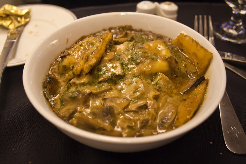 a bowl of soup with mushrooms and cheese