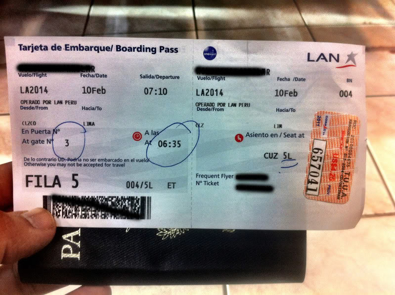 a hand holding a passport and a boarding pass