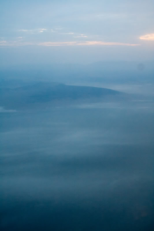 a view of the sun and clouds from an airplane window