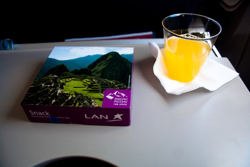 a glass of orange juice next to a box
