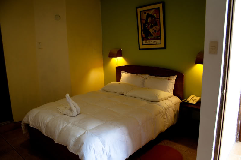 a bed with a white blanket and two lamps