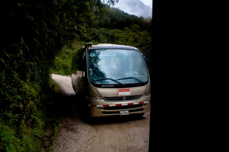a bus driving on a dirt road