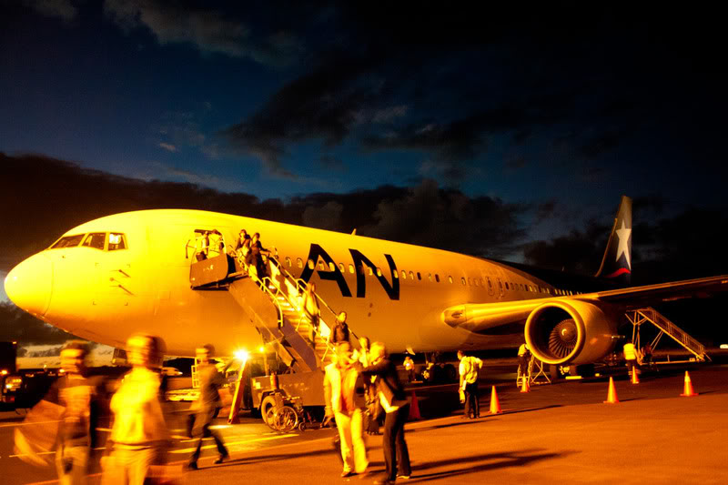 people walking down a plane at night