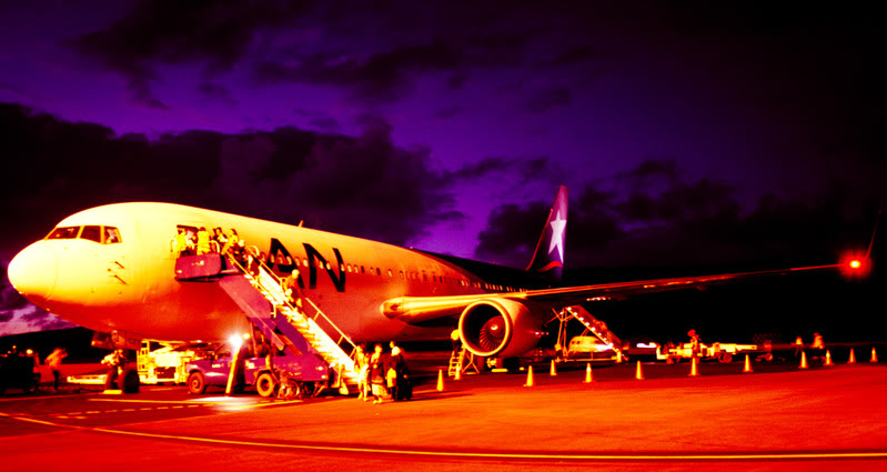 a plane with people boarding stairs