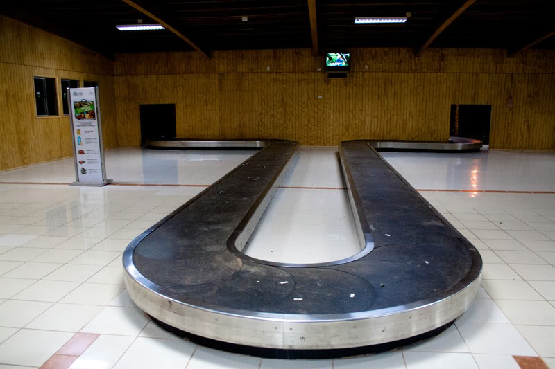 a luggage carousel in a room