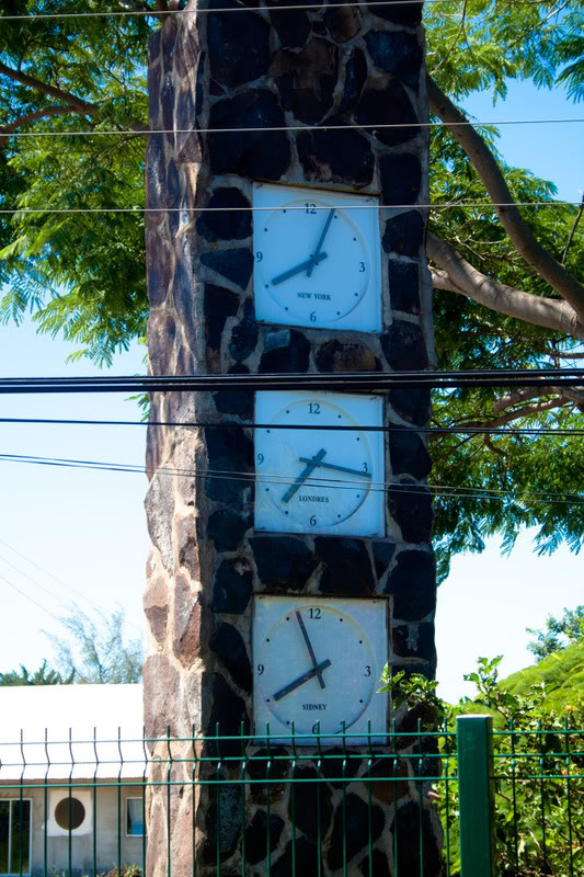 a stone tower with clocks on it