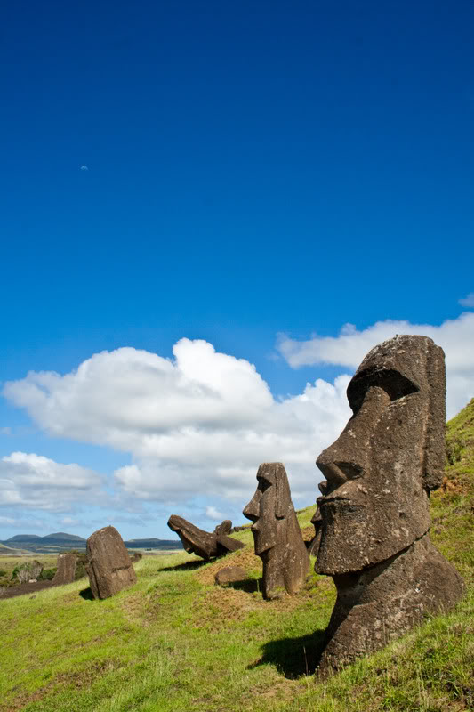 a group of stone statues on a hill