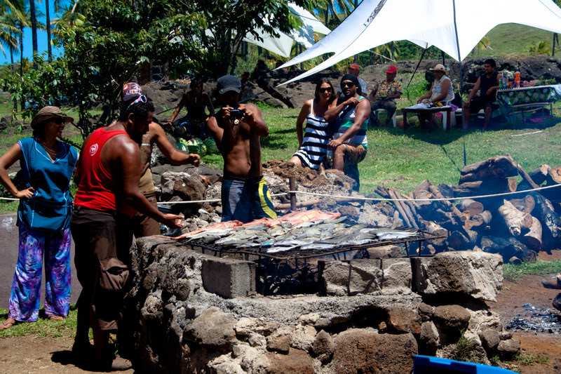 a group of people around a grill