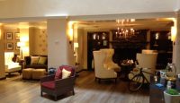 a room with a fireplace and chairs