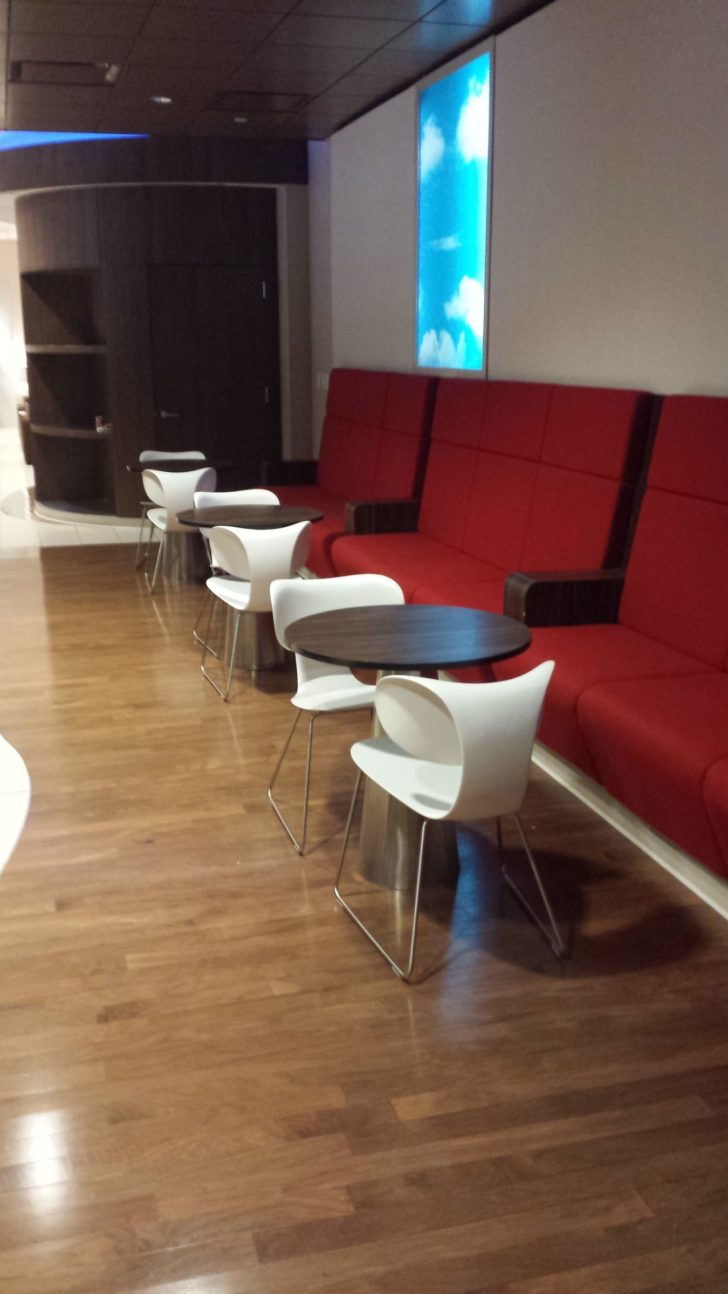a room with red couches and tables