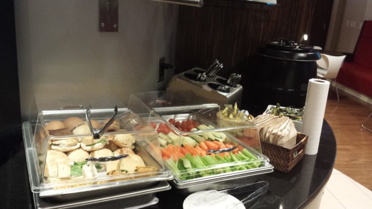 a buffet table with food in containers