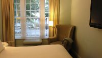a bedroom with a bed and a chair