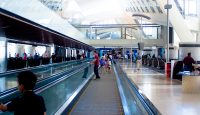 a group of people walking on an escalator