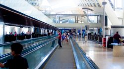 a group of people walking on an escalator