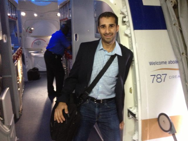 a man standing in a room with a bag