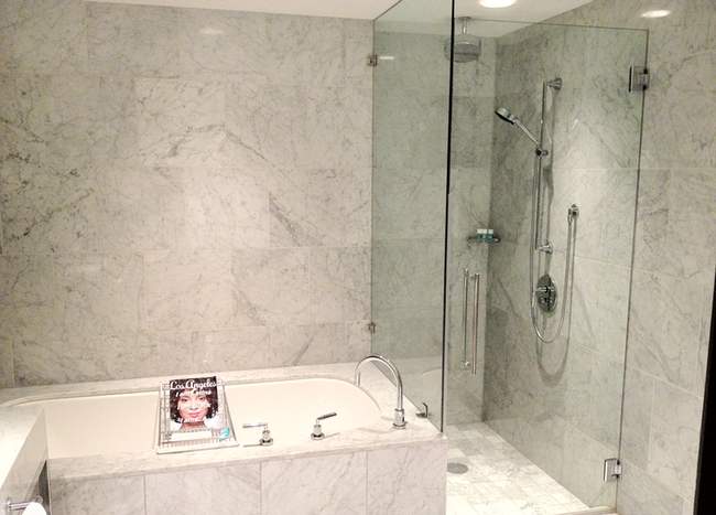 a bathroom with a glass shower and bathtub