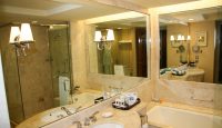 a bathroom with large mirrors