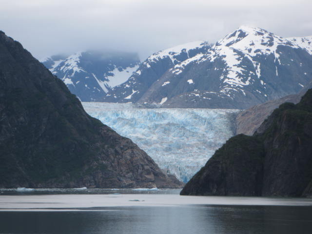 a glacier next to a body of water with Tracy Arm in the background