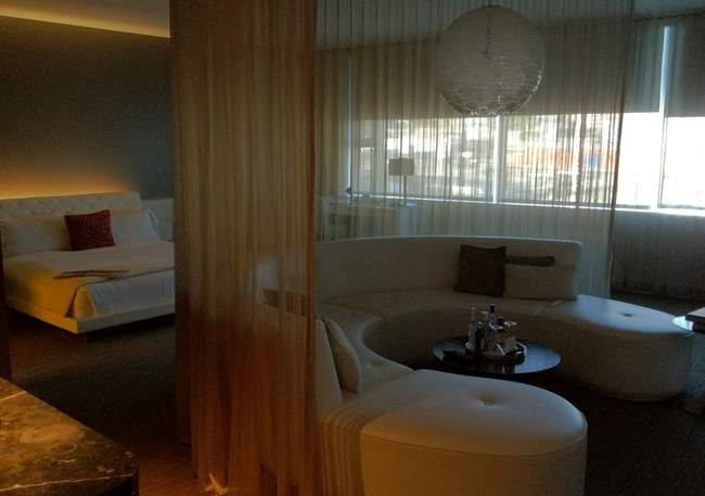 a room with a round couch and a bed