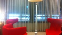 a red chair and a lamp in a room