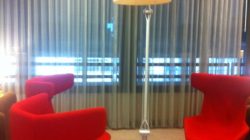a red chair and a lamp in a room