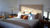 a bed with a lamp and a table