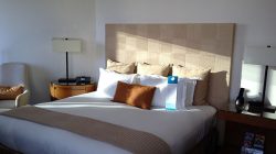 a bed with a lamp and a table
