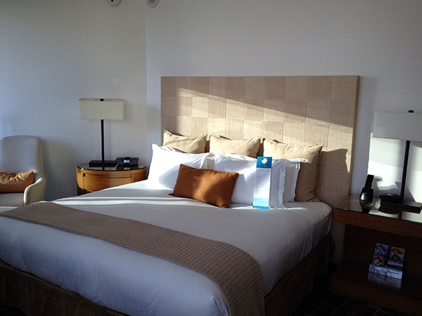 a bed with a lamp and a table