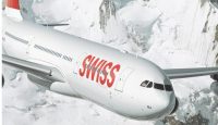 a plane flying over snow covered mountains