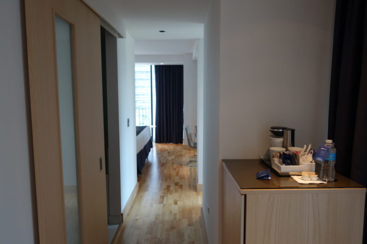 More entry hallway. Bathroom with sliding door on the left.