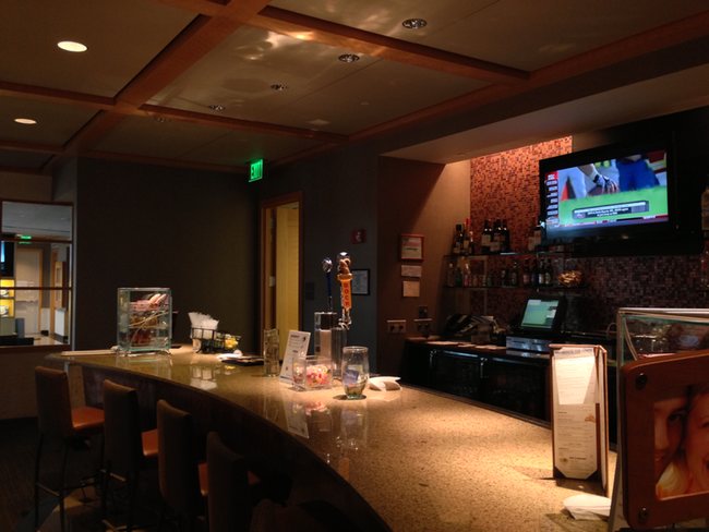 a bar with a television on the wall