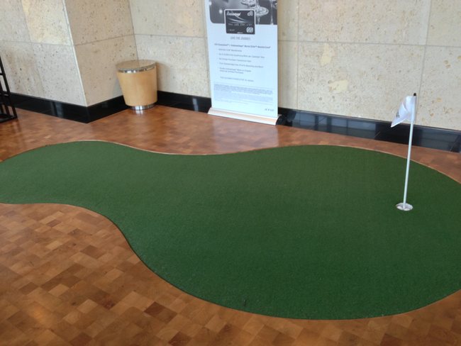 a person playing golf on a green golf course
