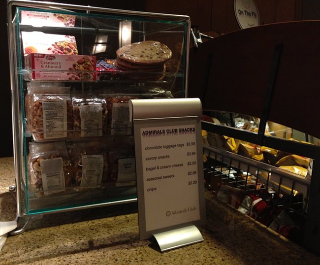 a display case with a sign and a bar of snacks