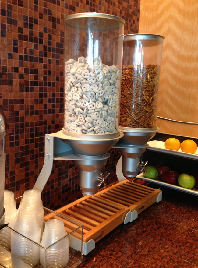 a food dispenser with a couple of containers of pretzels and pretzels
