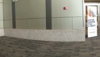 a stone floor with a grey wall