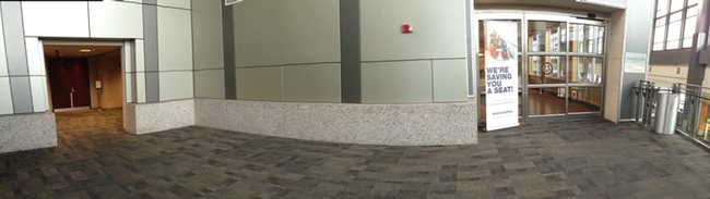 a stone floor with a grey wall