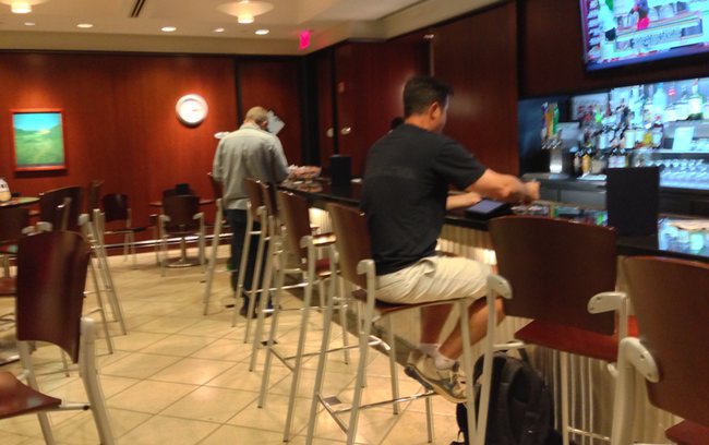 a group of people sitting at a bar