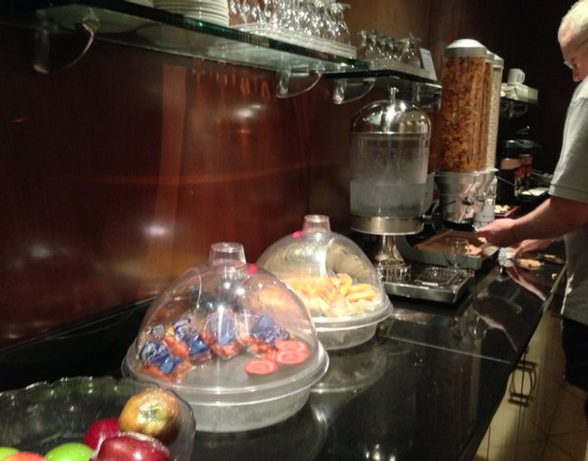 a person standing at a counter with food in containers