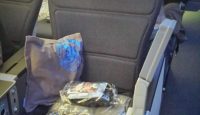 a seat with a bag and a pillow