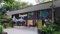 a building with a sign and trees