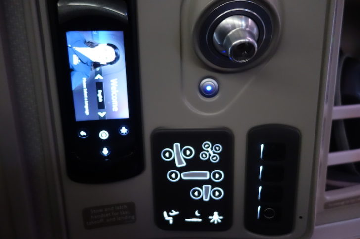 Seat controls, IFE remote, and reading light