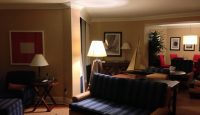 a living room with a couch and a lamp